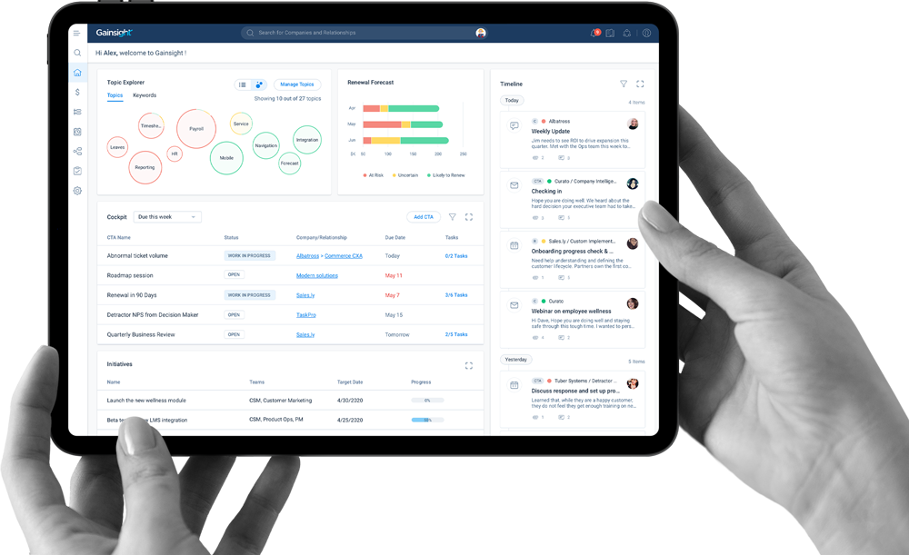 Image of a hand holding a tablet showing Gainsight's software